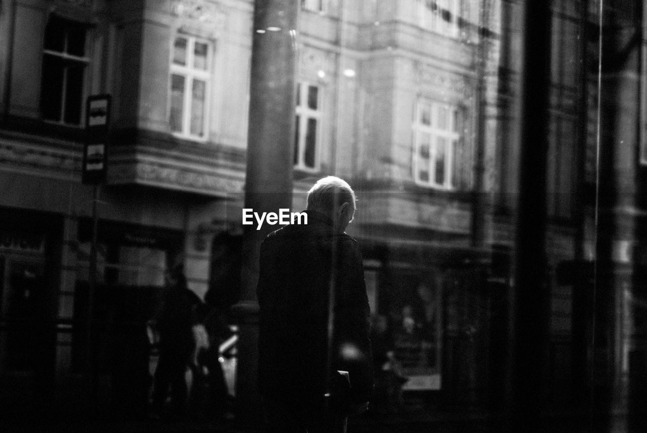 Man seen through window