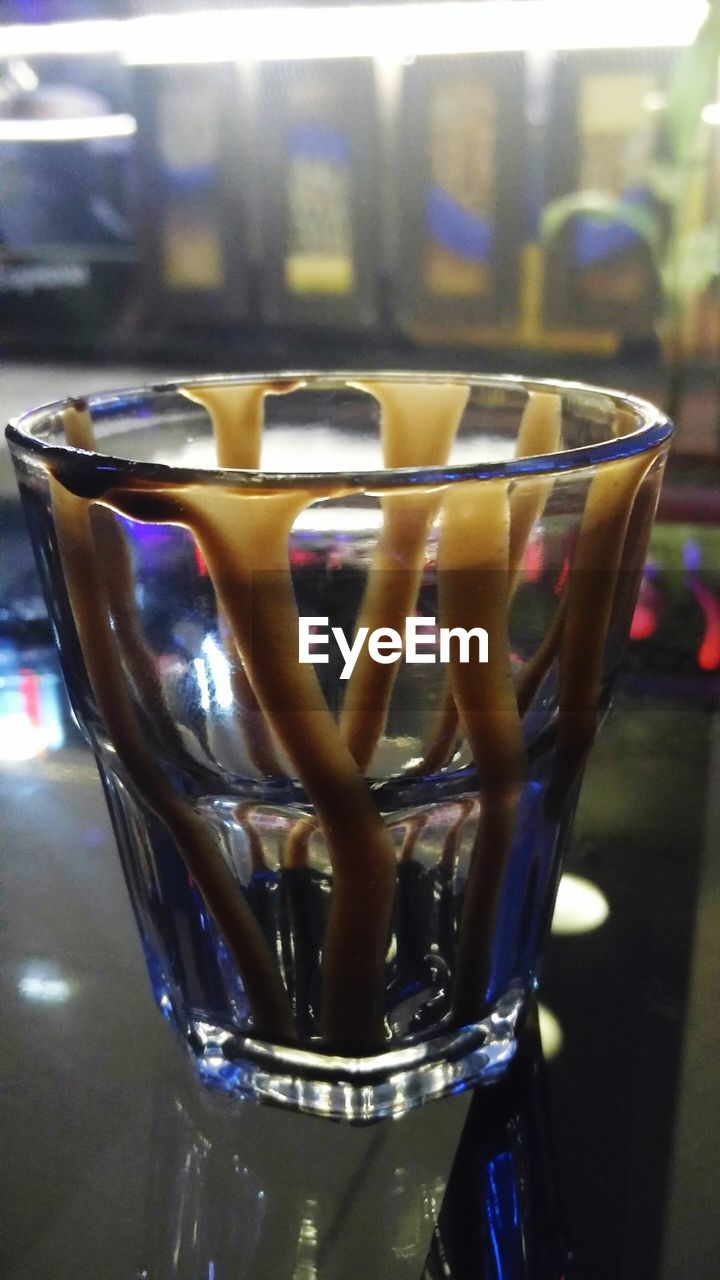 CLOSE-UP OF WINE GLASSES ON TABLE