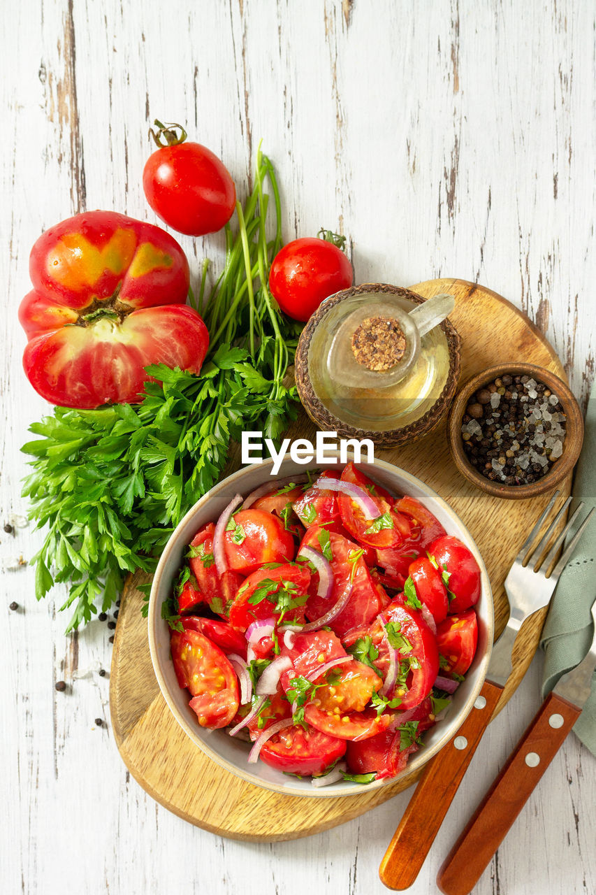 Summer snack or lunch. fresh tomato salad with onions, herbs and olive oil. 