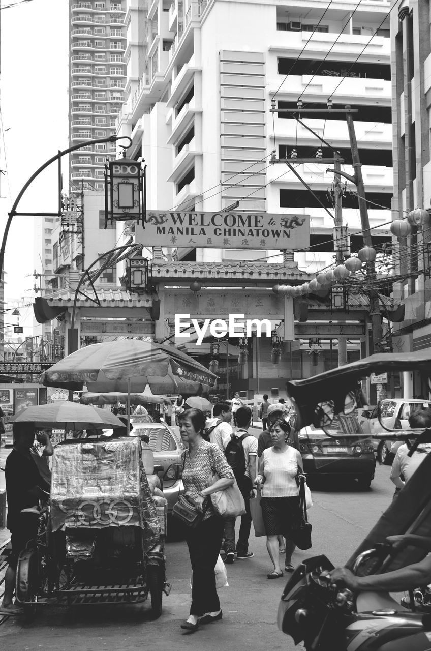 PEOPLE WALKING ON CITY STREET