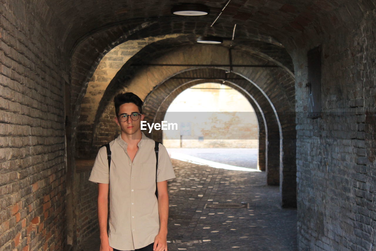 Portrait of boy standing at tunnel