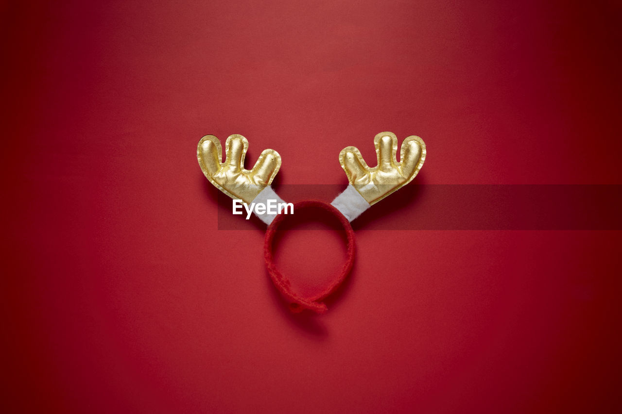 Funny santa reindeer headband horns isolated on a red background. top view with copy space.