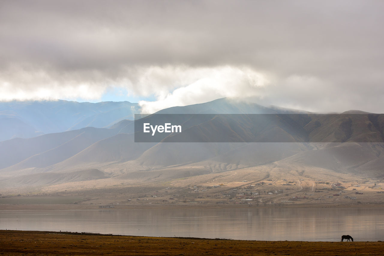 Cloudscape over river and mountain