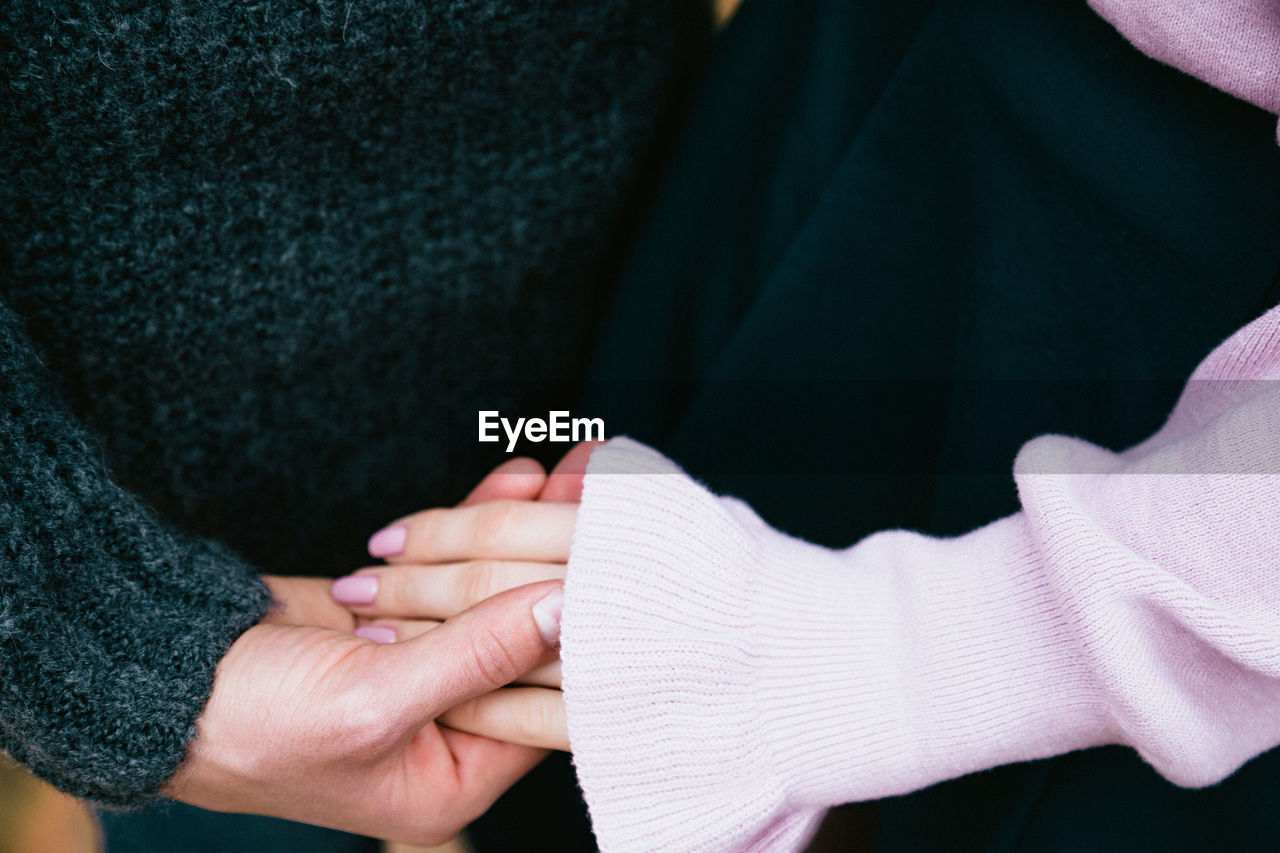 Close-up of couple holding hands