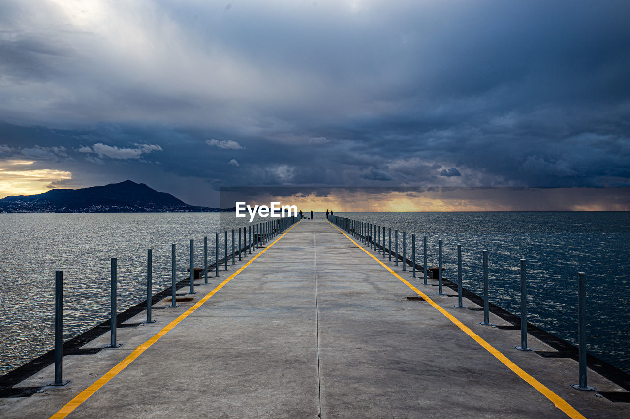 PIER AMIDST SEA AGAINST SKY