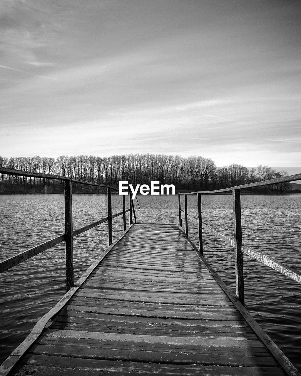 Pier over lake against sky