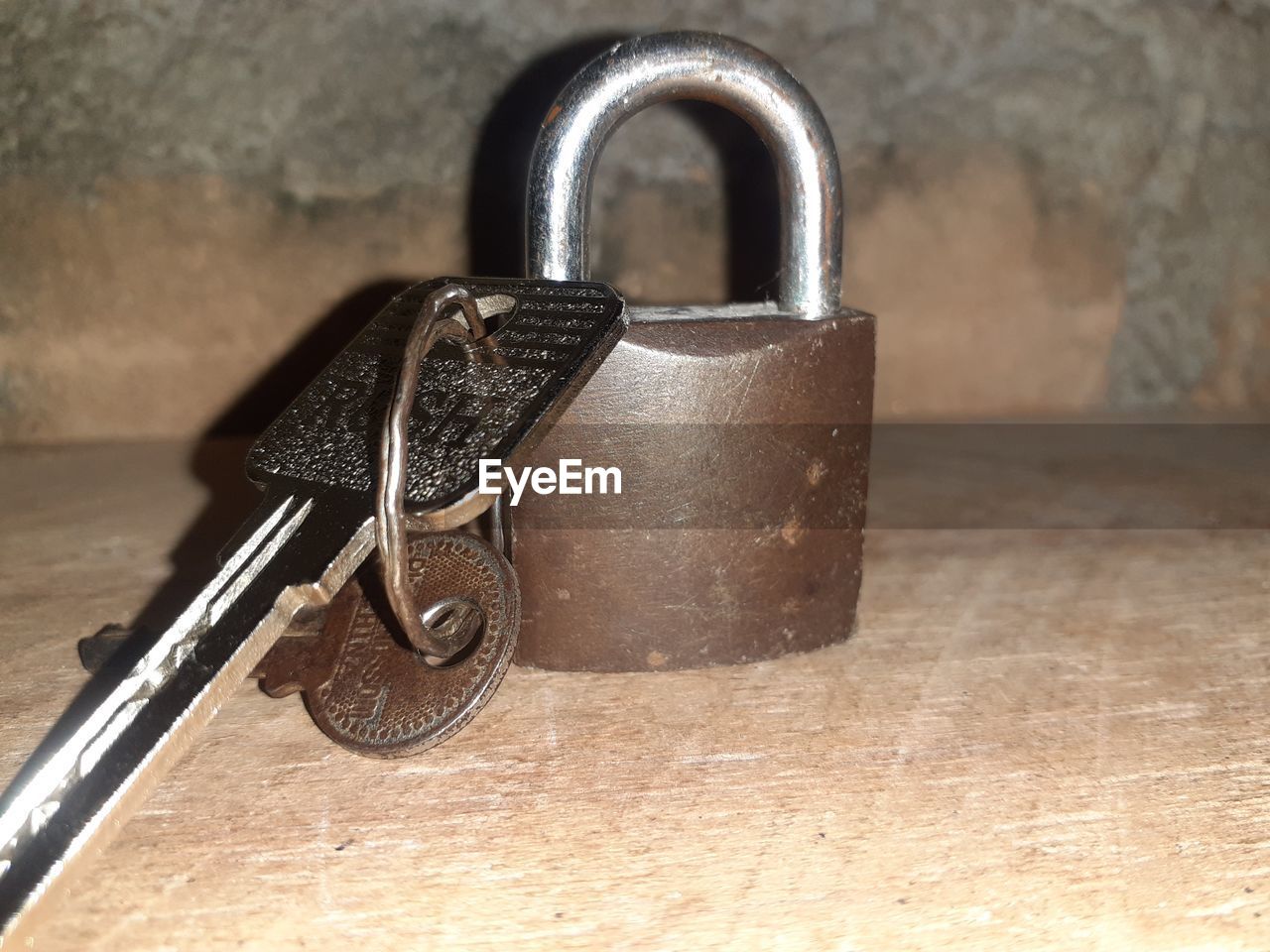 close-up of padlock on wooden wall