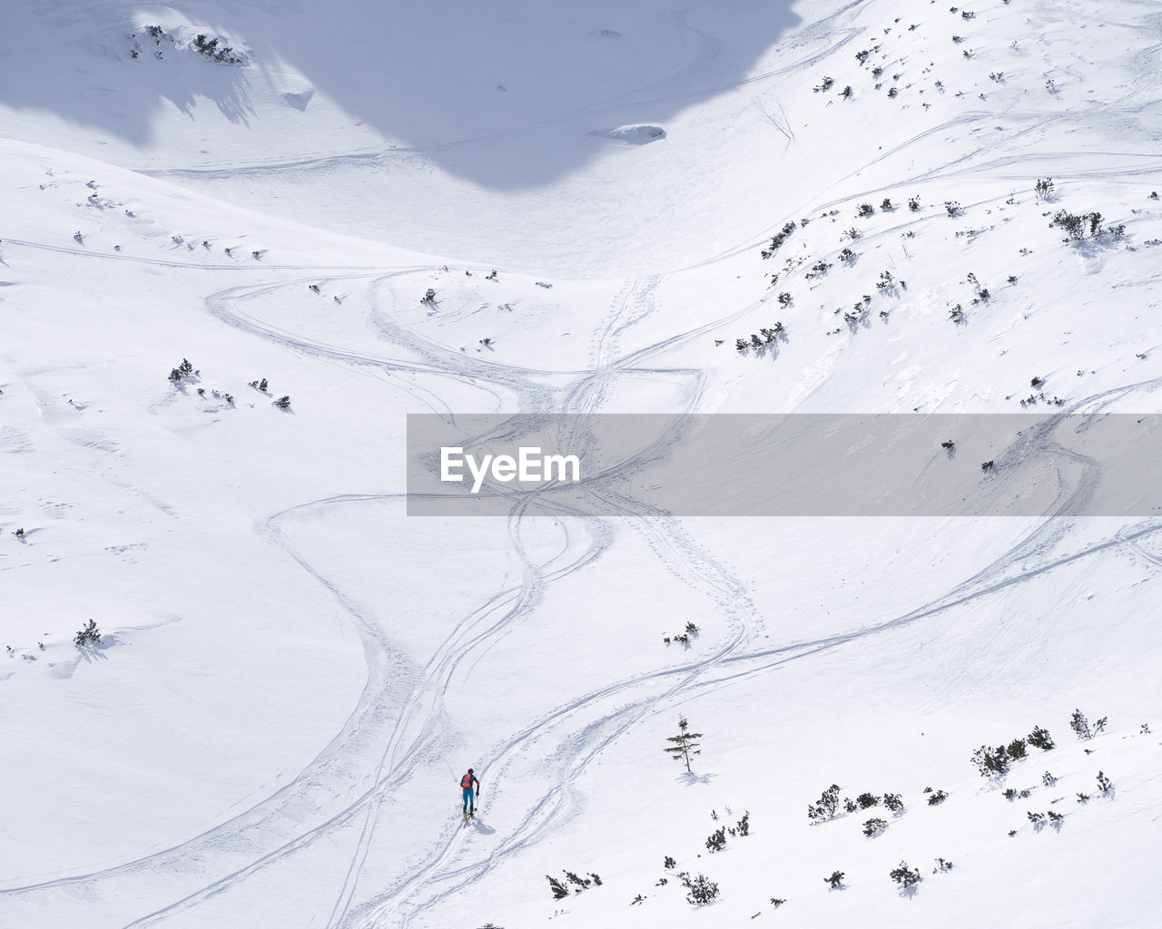 Ski alpinist roaming through alpine valley full of snow, slovakia, europe