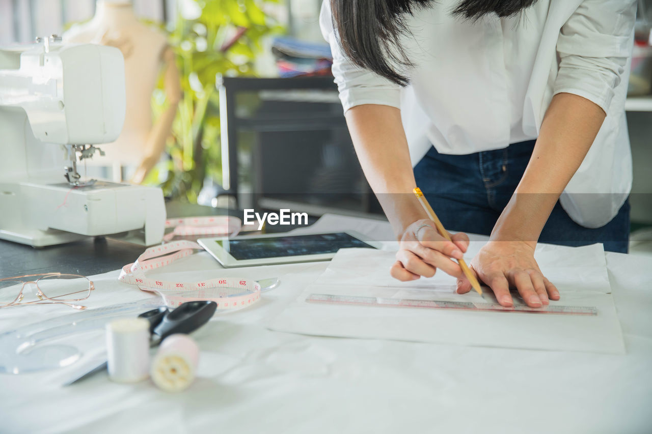 Midsection of woman working on table