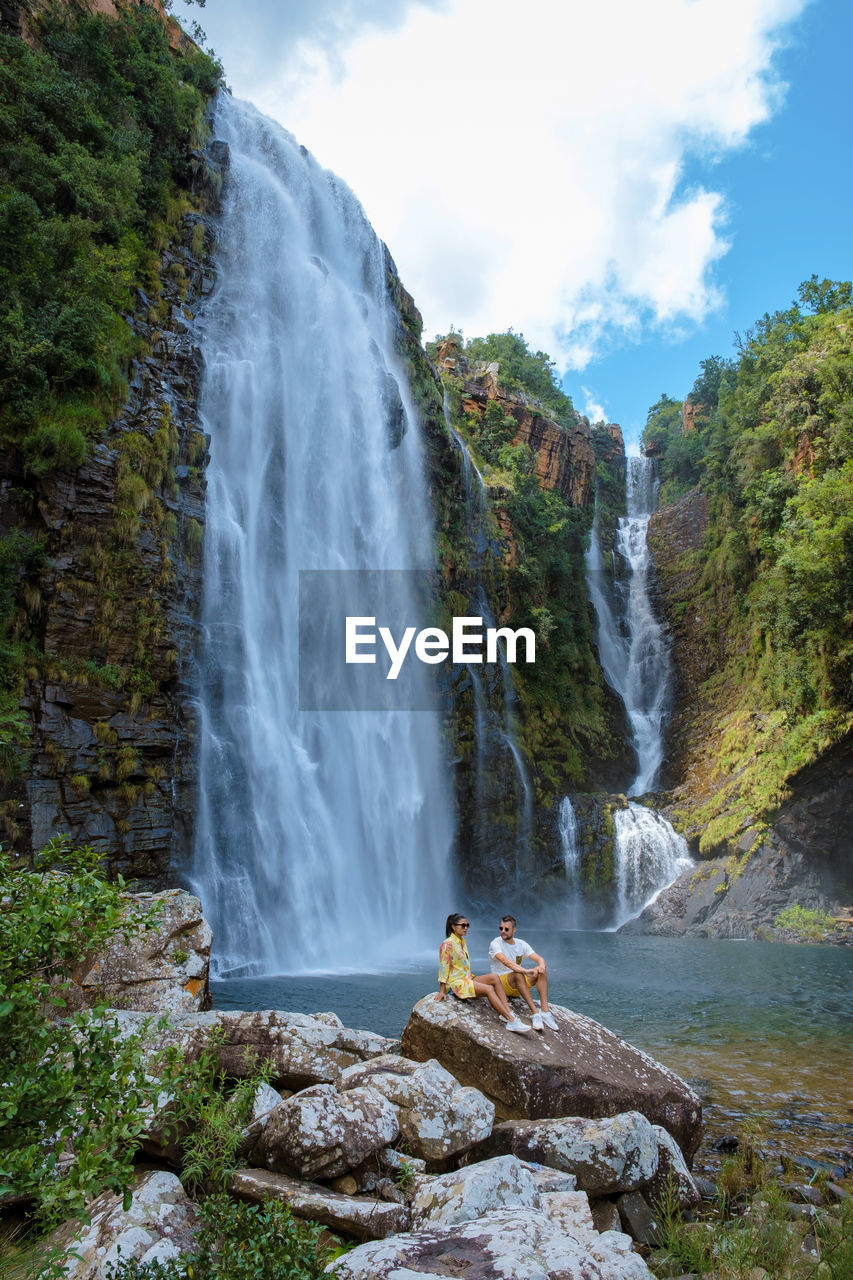 scenic view of waterfall against sky