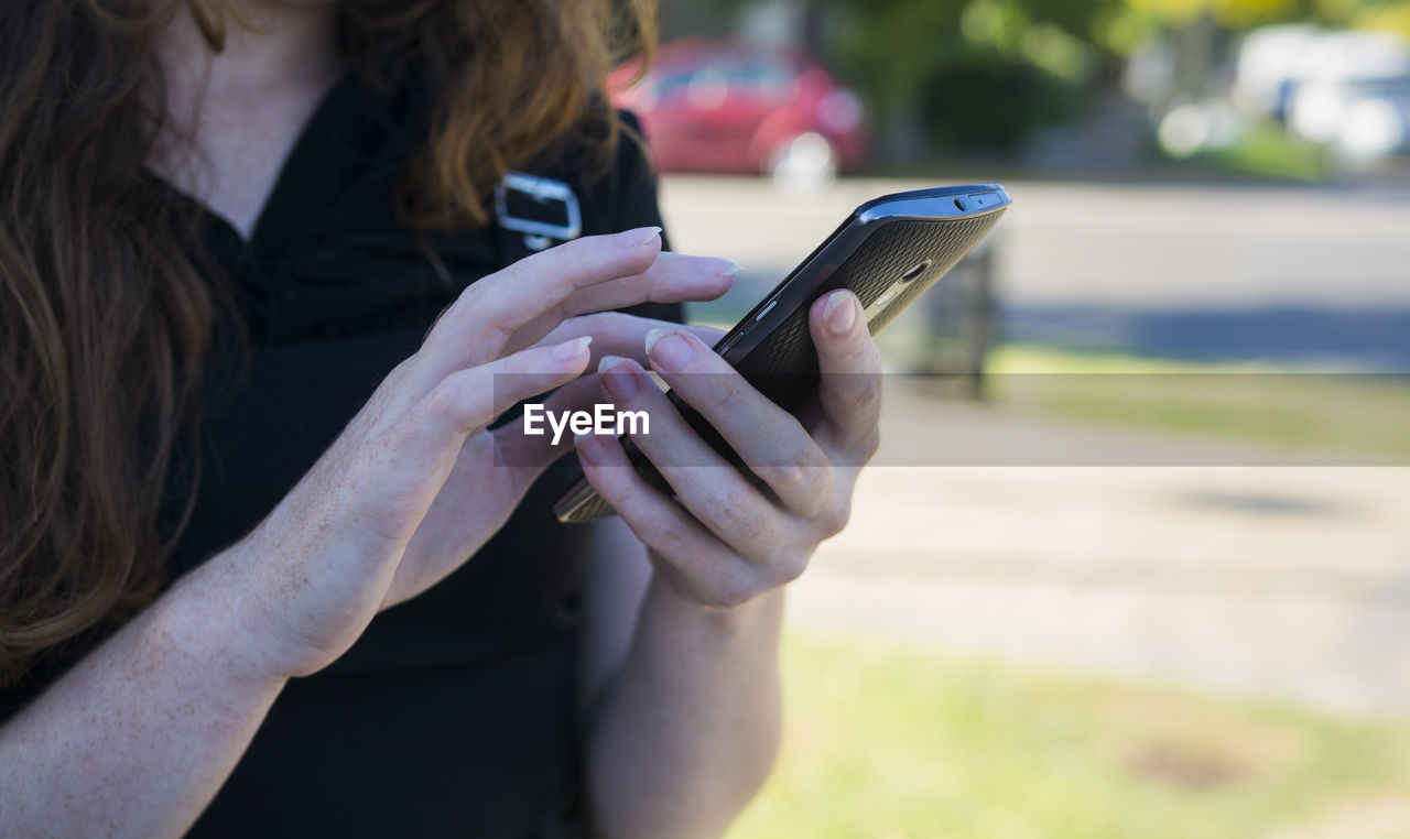 WOMAN USING MOBILE PHONE