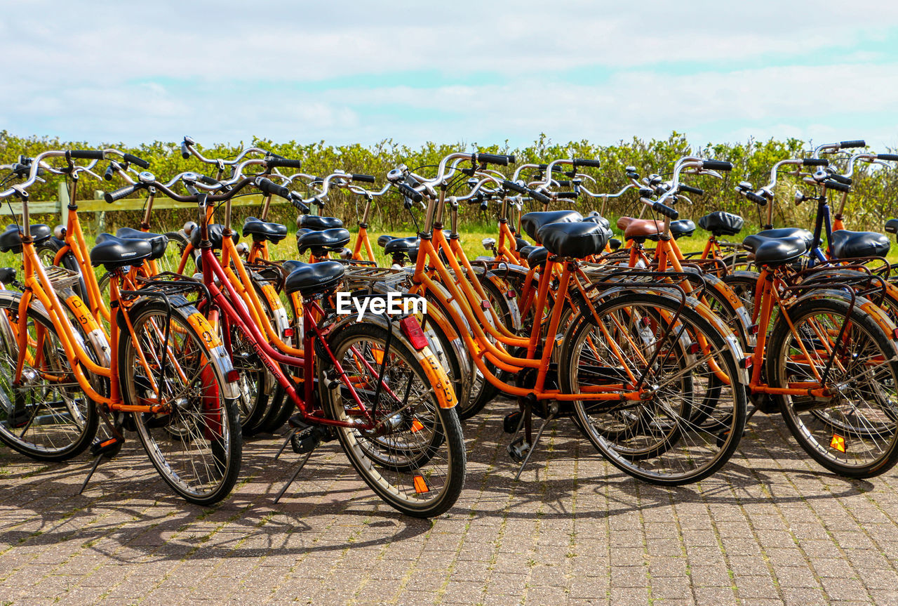 CLOSE-UP OF BICYCLES AGAINST SKY