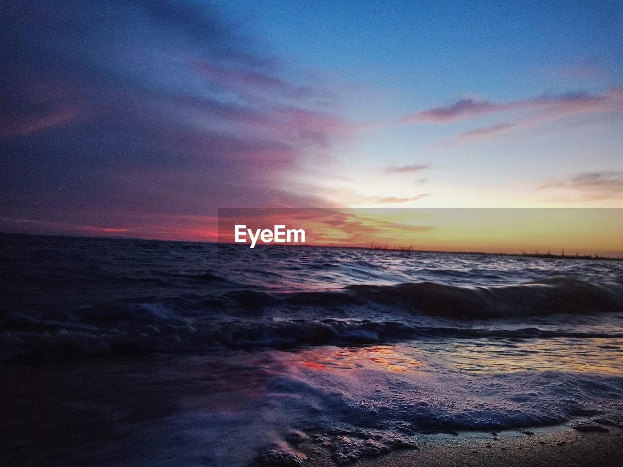 SCENIC VIEW OF BEACH DURING SUNSET