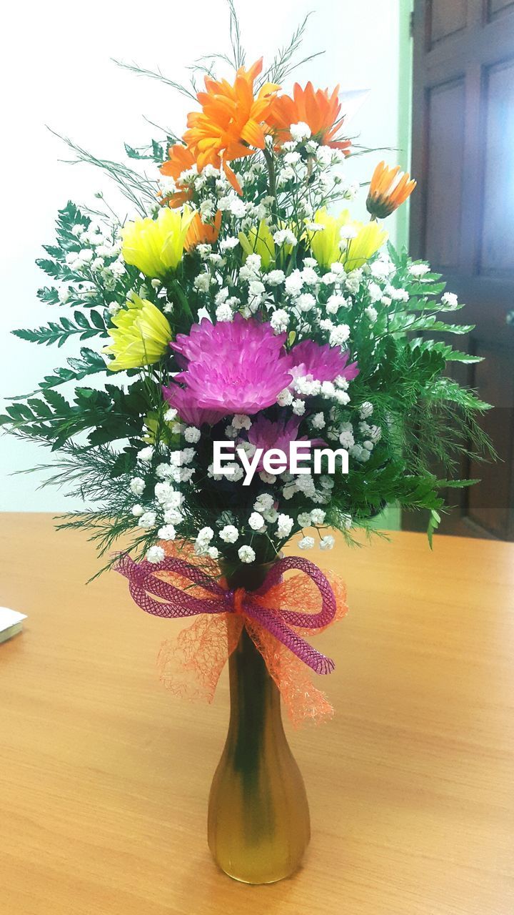 Close-up of flower vase on table at home