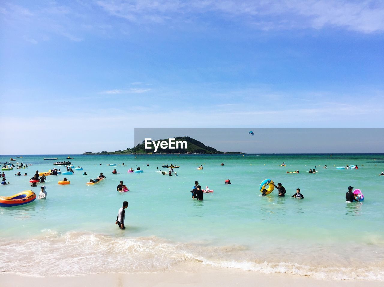 PEOPLE ON BEACH AGAINST SKY