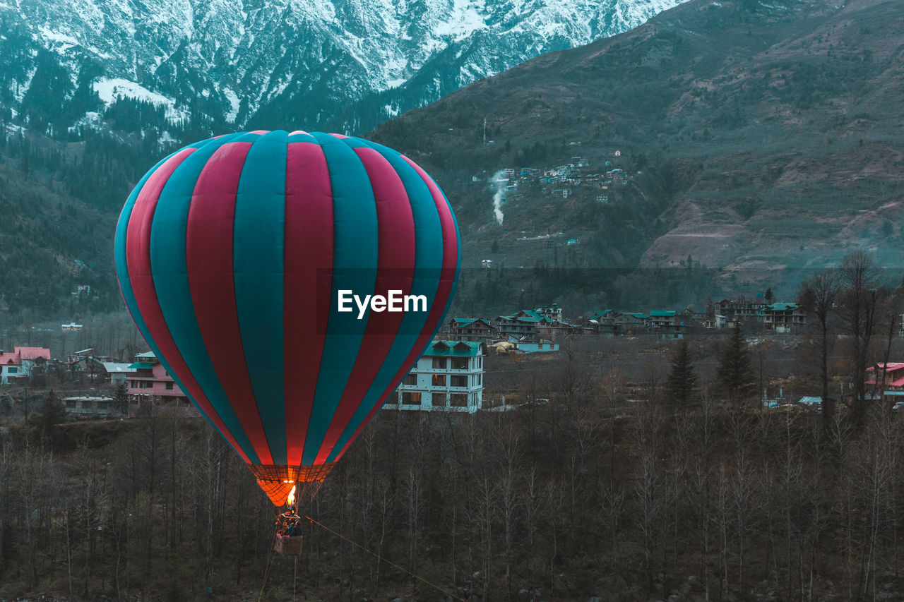 Hot air balloons flying over mountain
