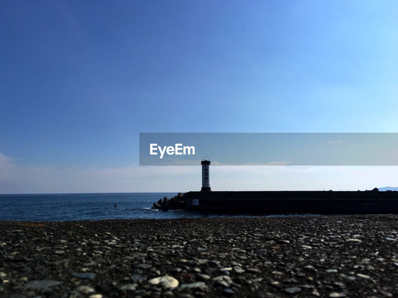 Scenic view of beach and sea against blue sky