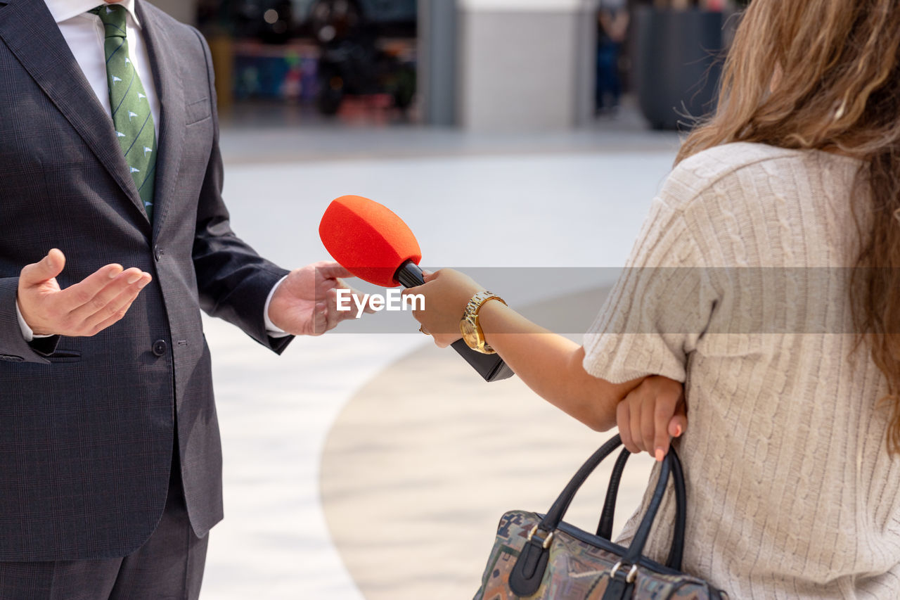 Media interview with rich man, wealthy person or businessman wearing elegant suit