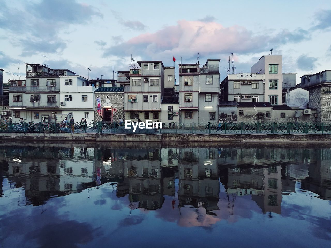 Reflection of buildings on river at sunset