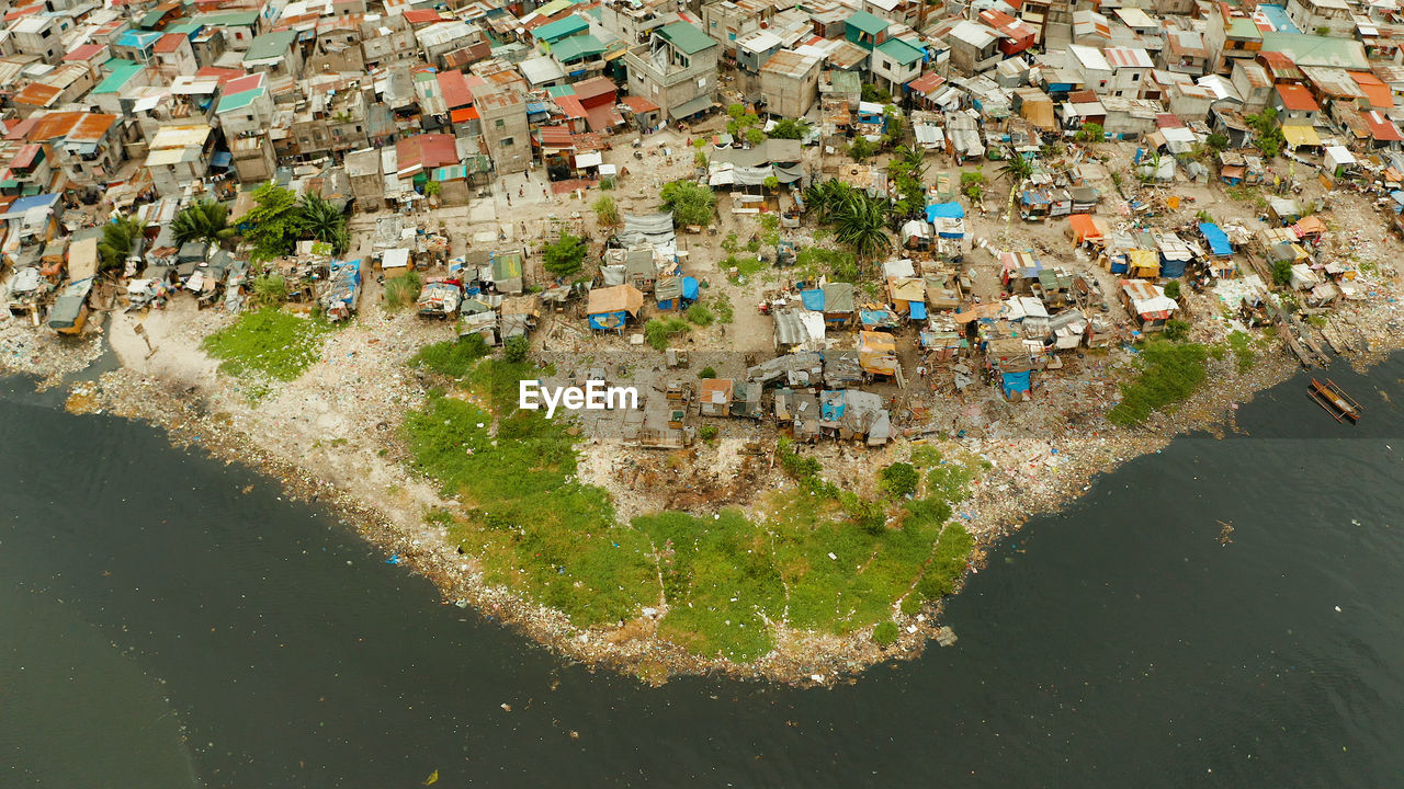 Poor district and slums in manila with shacks and buildings. manila, philippines.