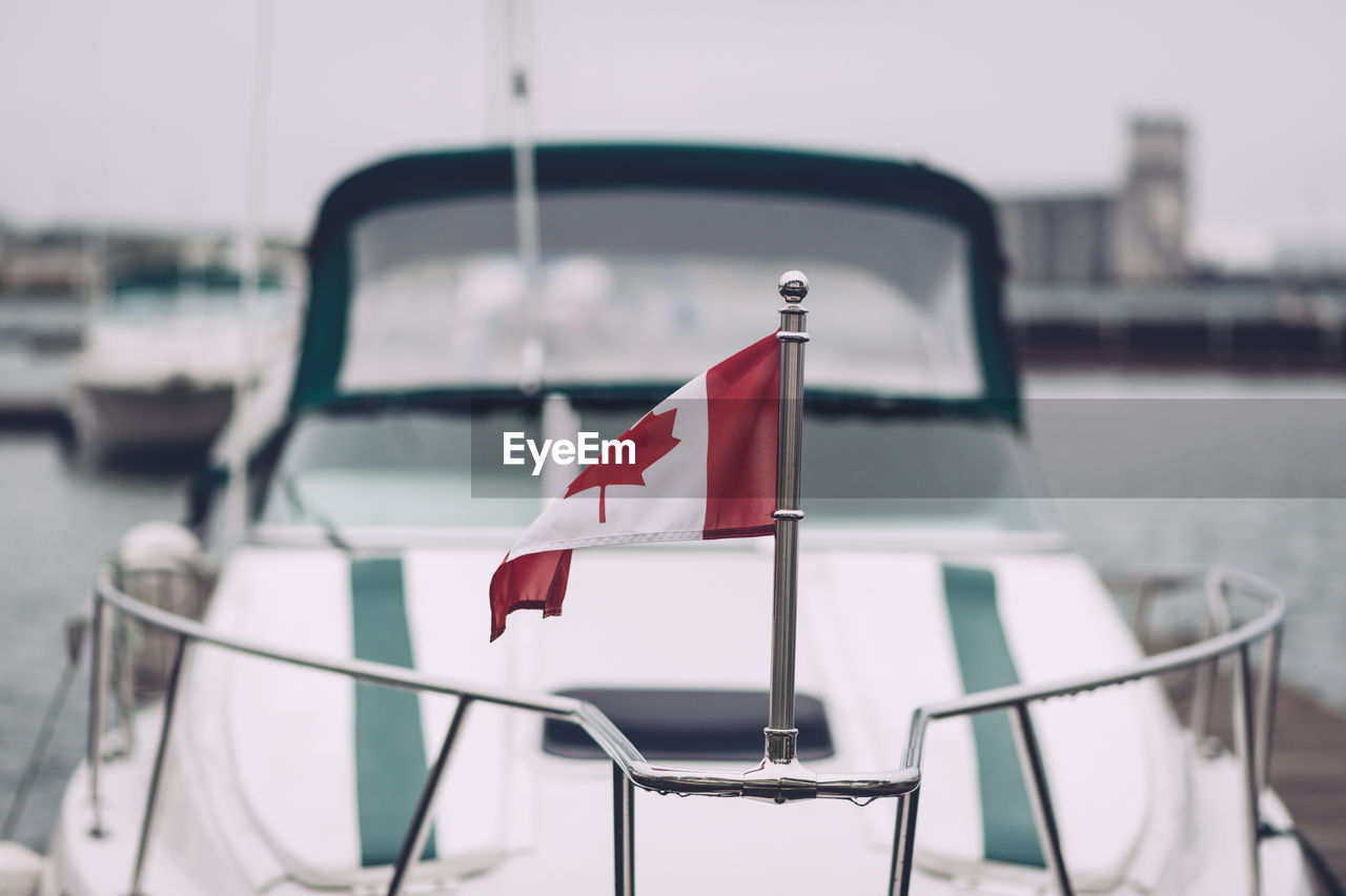 Canadian flag on railing of boat
