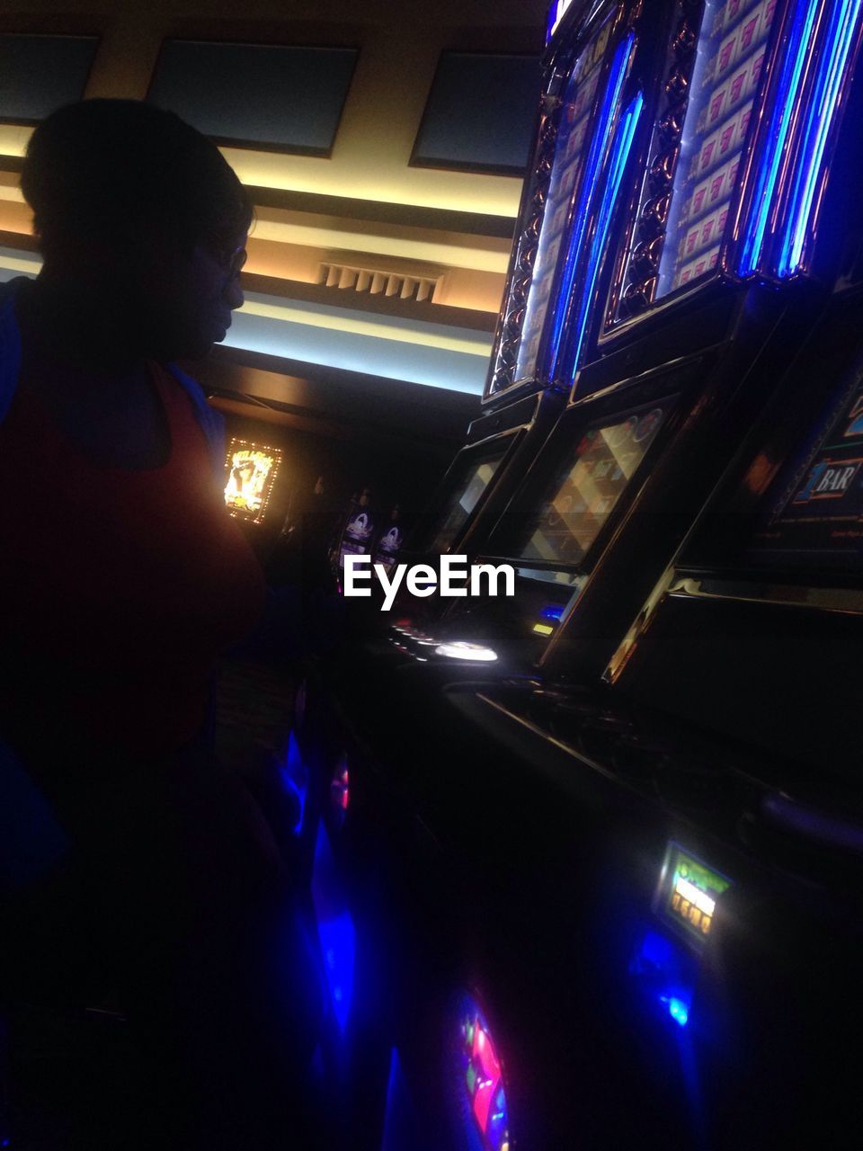 Woman playing slot machine in emerald queen casino