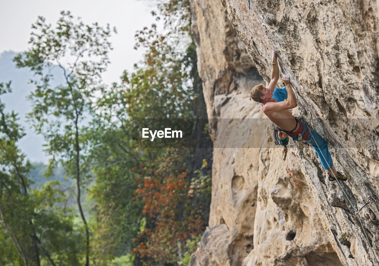 Man climbing on the limestone cliff "white mountain" in yangshuo