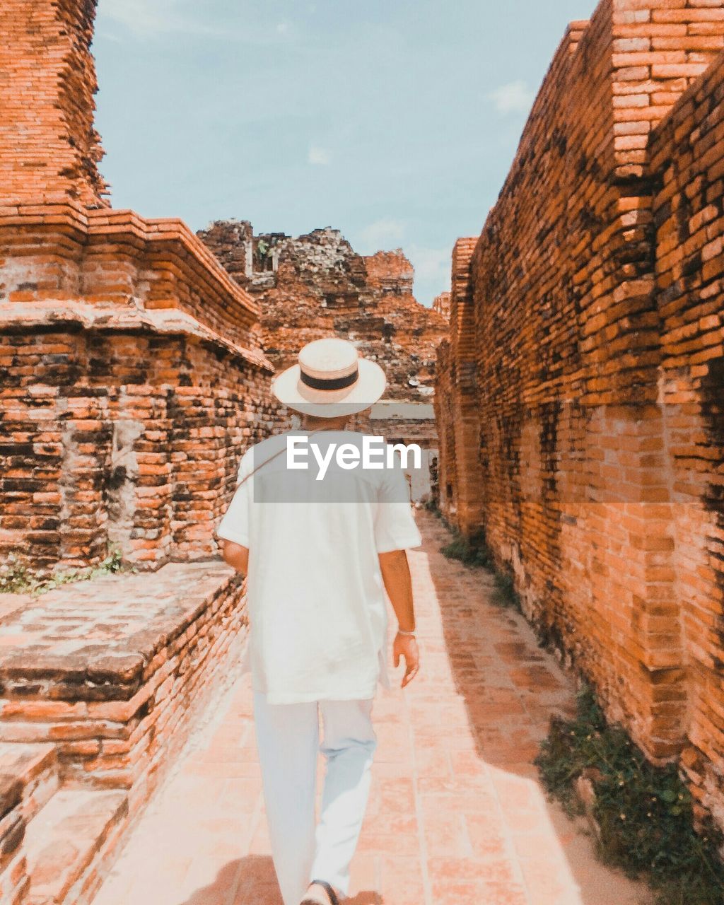 Rear view of man walking at old ruins