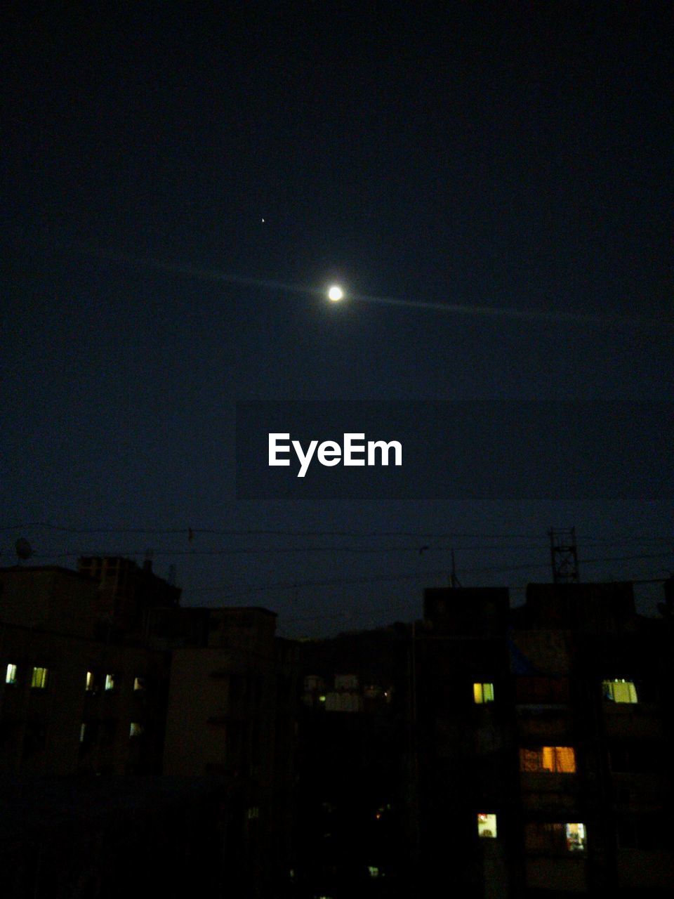 LOW ANGLE VIEW OF ILLUMINATED BUILDINGS AGAINST SKY