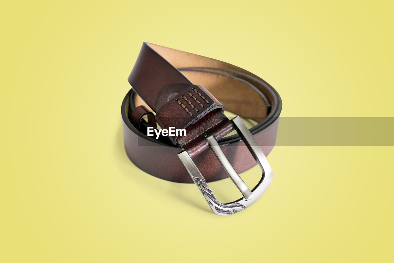 Brown fashion leather belt isolated on pastel color background with clipping path.
