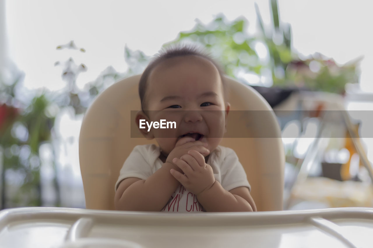 Portrait of baby boy sitting on chair