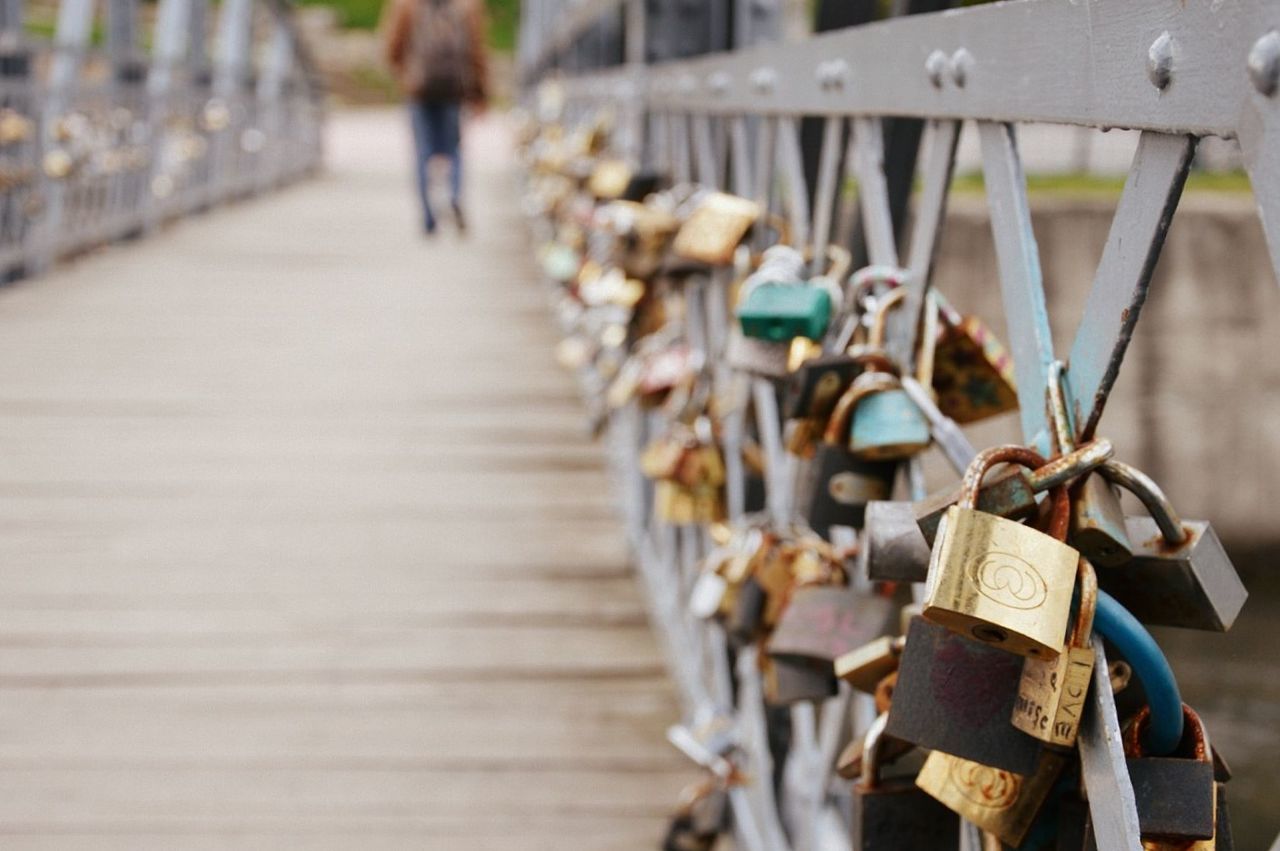 CLOSE-UP OF PADLOCKS ON FOOTBRIDGE