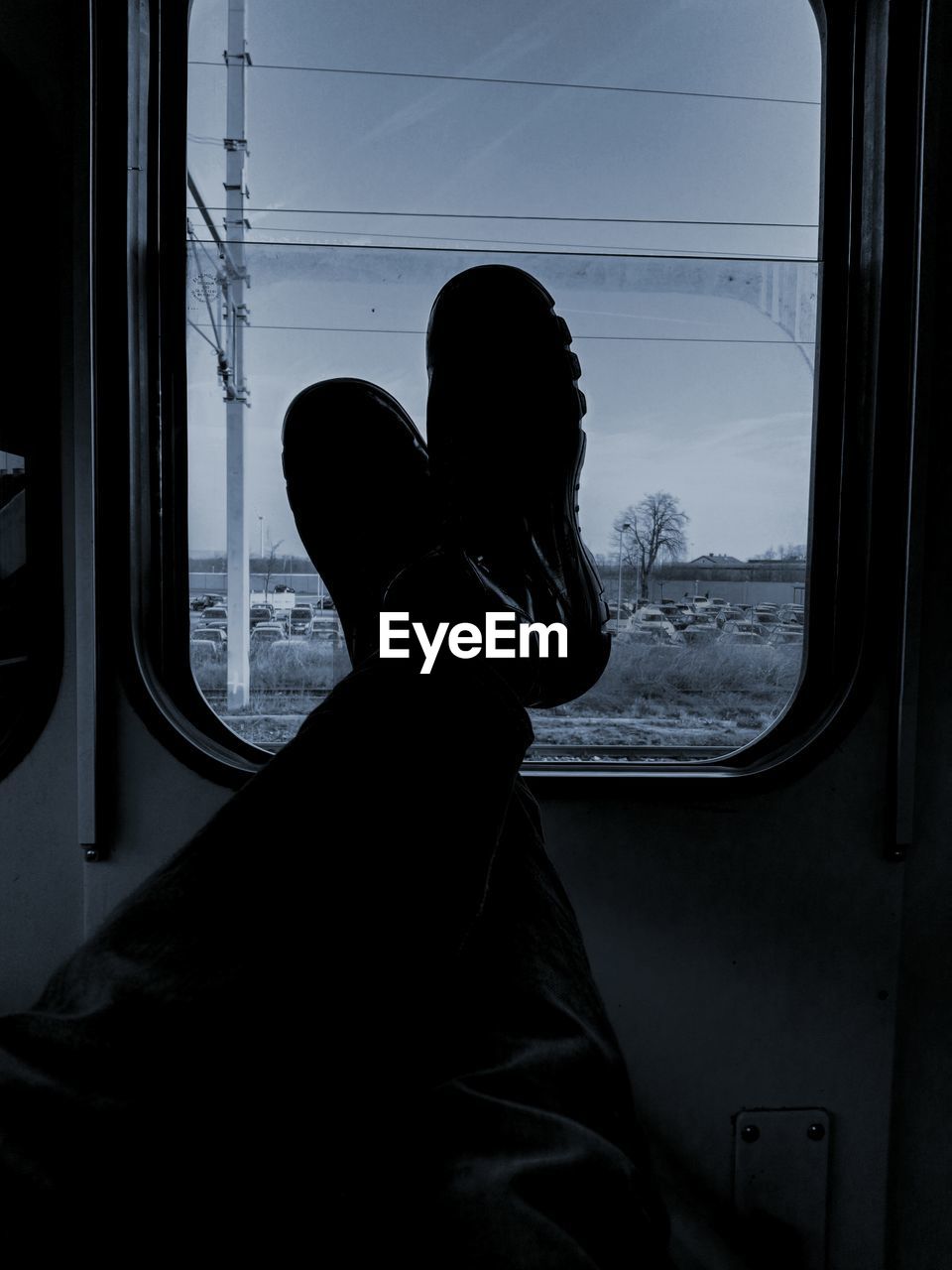 Low section of man by window in train
