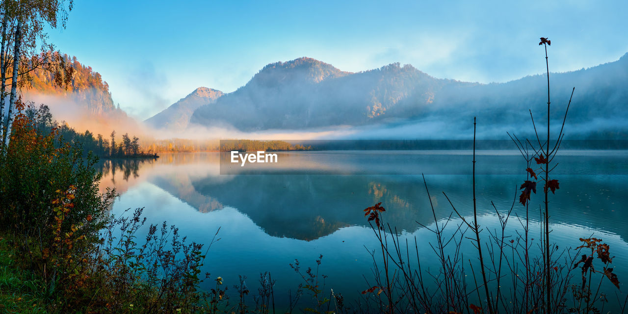 Scenic view of lake and mountains against sky