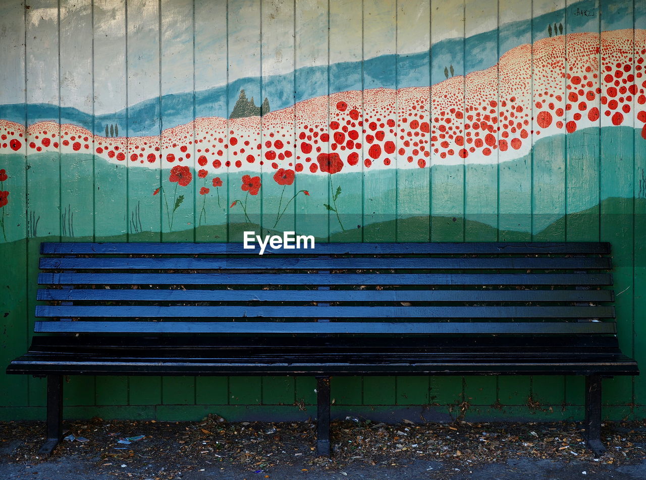 EMPTY BENCHES IN SWIMMING POOL AGAINST WALL