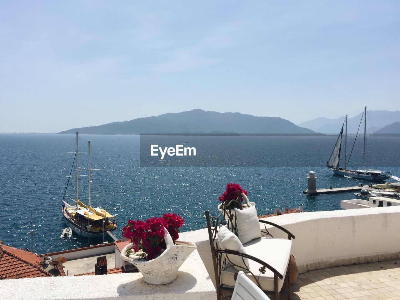 SAILBOATS MOORED ON SEA AGAINST SKY