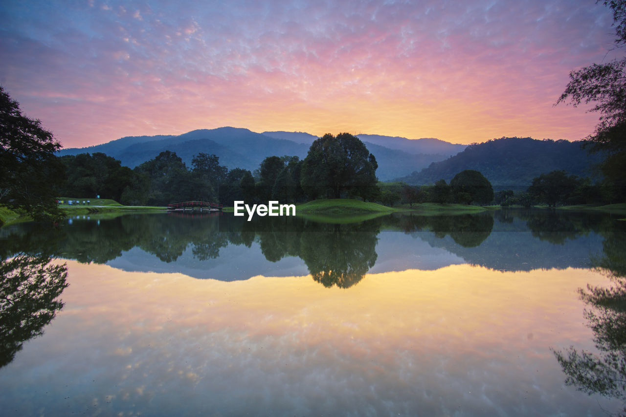 Scenic view of lake against sky during sunset