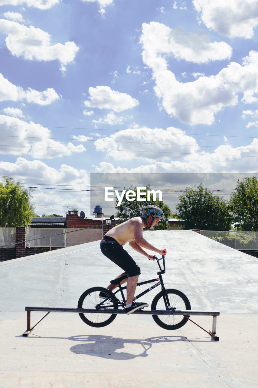 MAN RIDING BICYCLE IN WATER