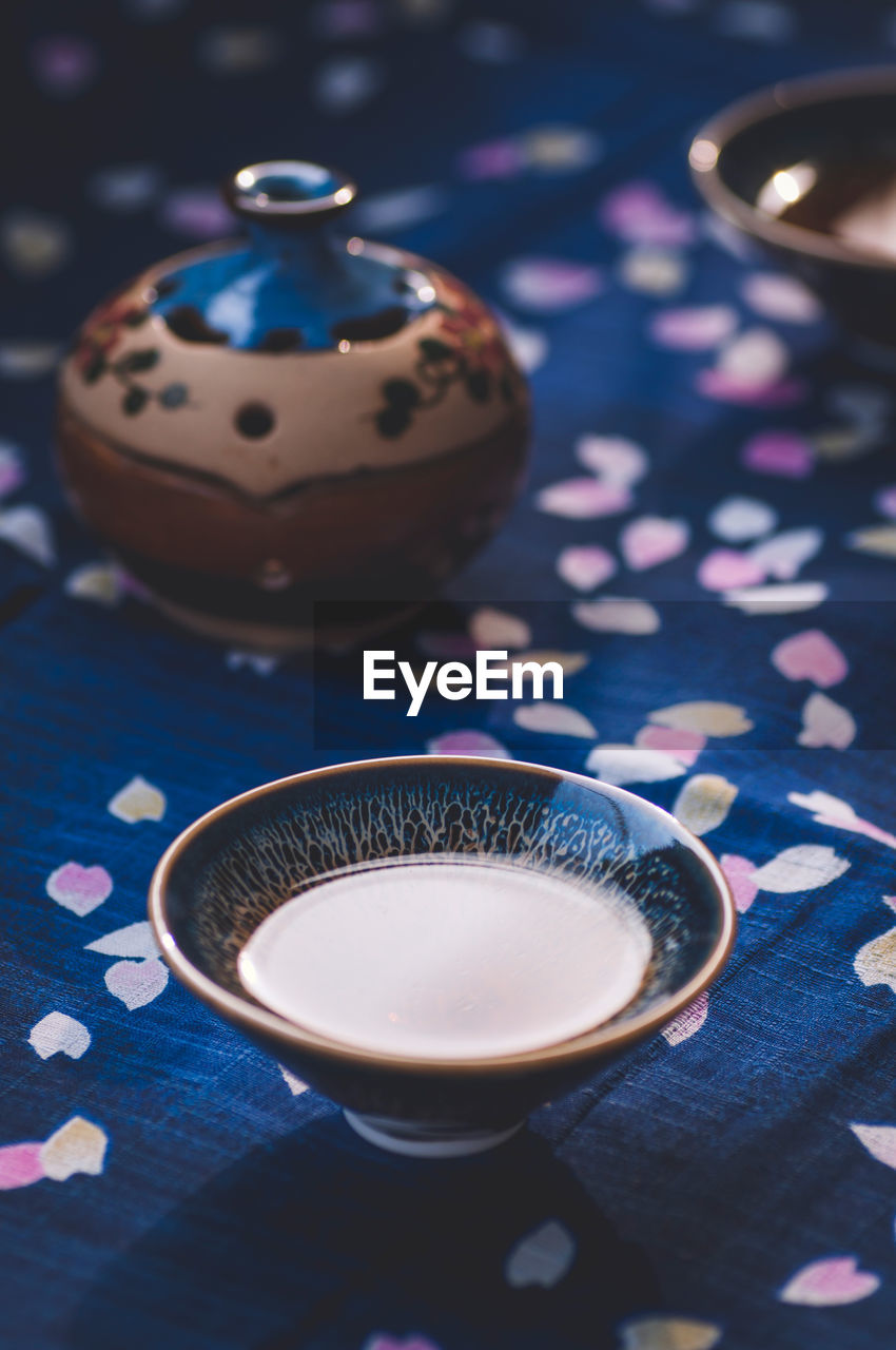 Drink in tenmoku on tablecloth