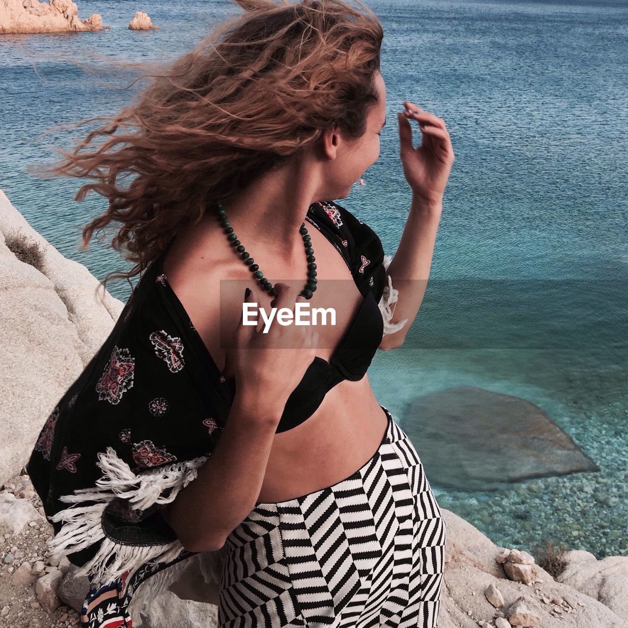 Young woman standing at beach