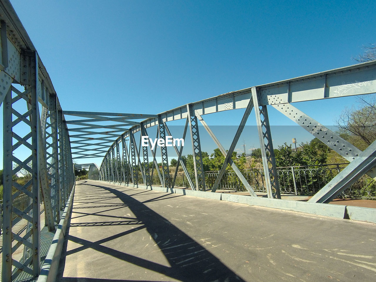 VIEW OF BRIDGE AGAINST CLEAR BLUE SKY