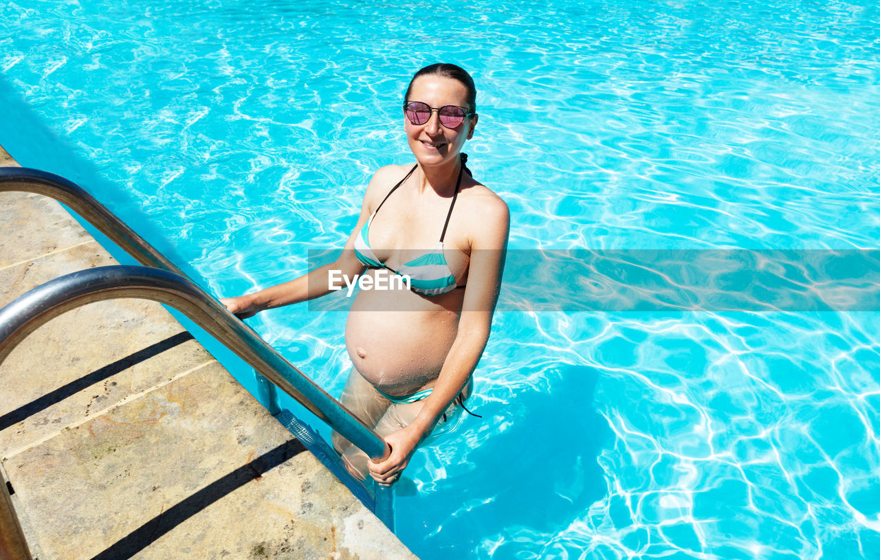 portrait of young woman swimming in pool