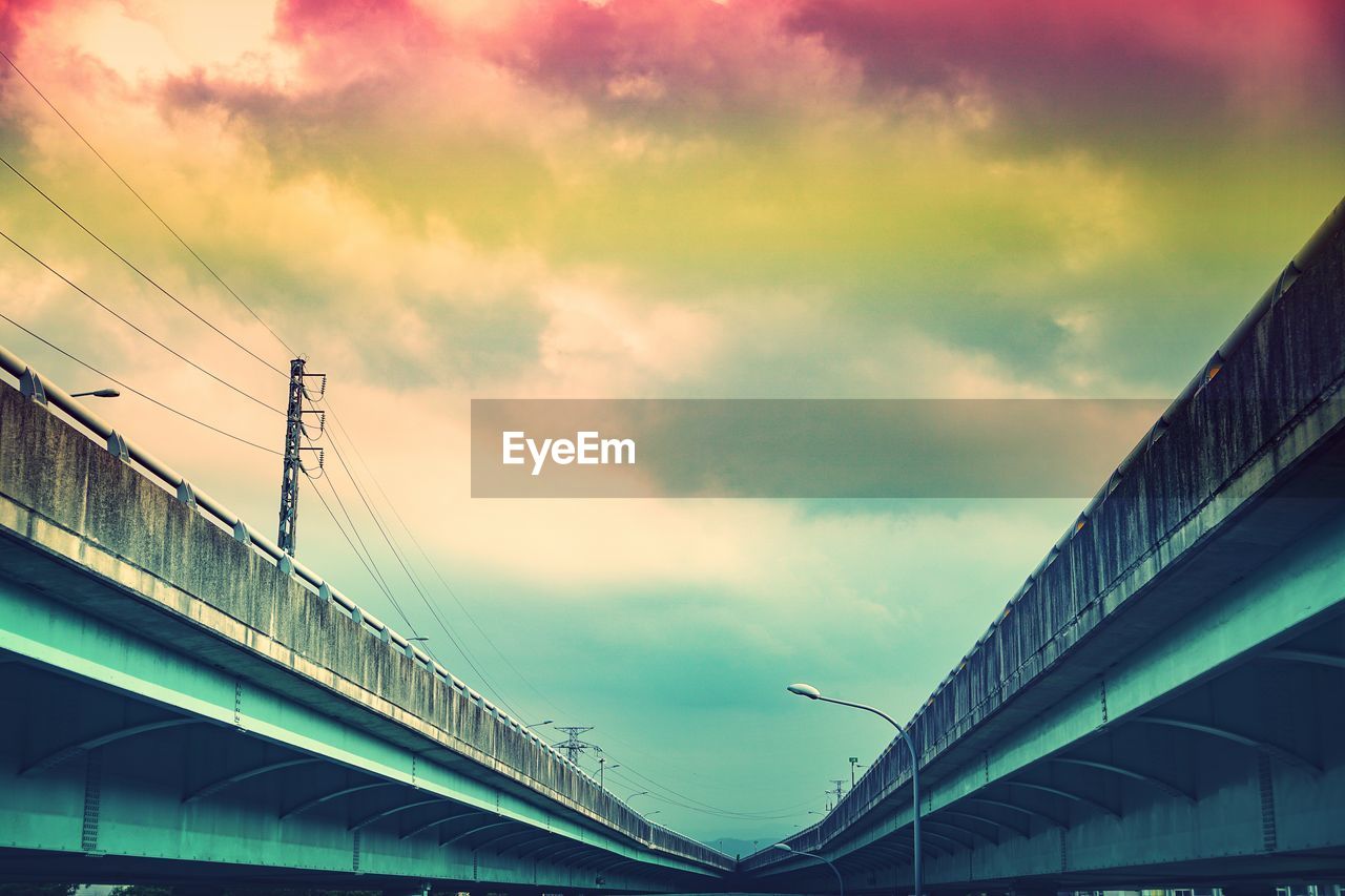 Low angle view of bridge against romantic sky during sunset