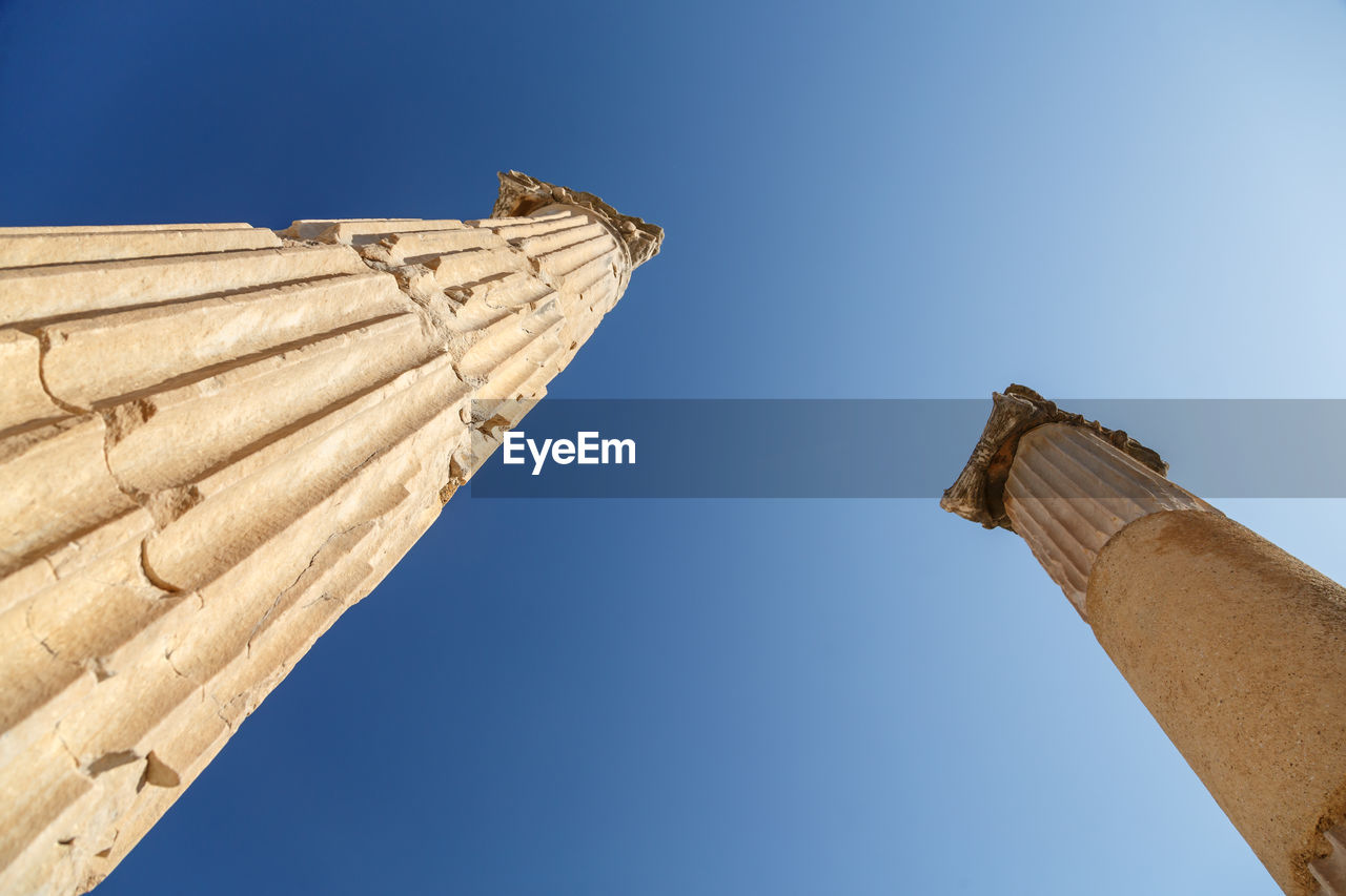 Low angle view of historical building against clear blue sky