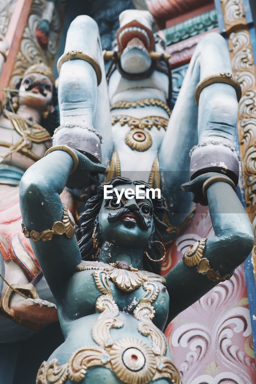 LOW ANGLE VIEW OF BUDDHA STATUE OUTSIDE TEMPLE