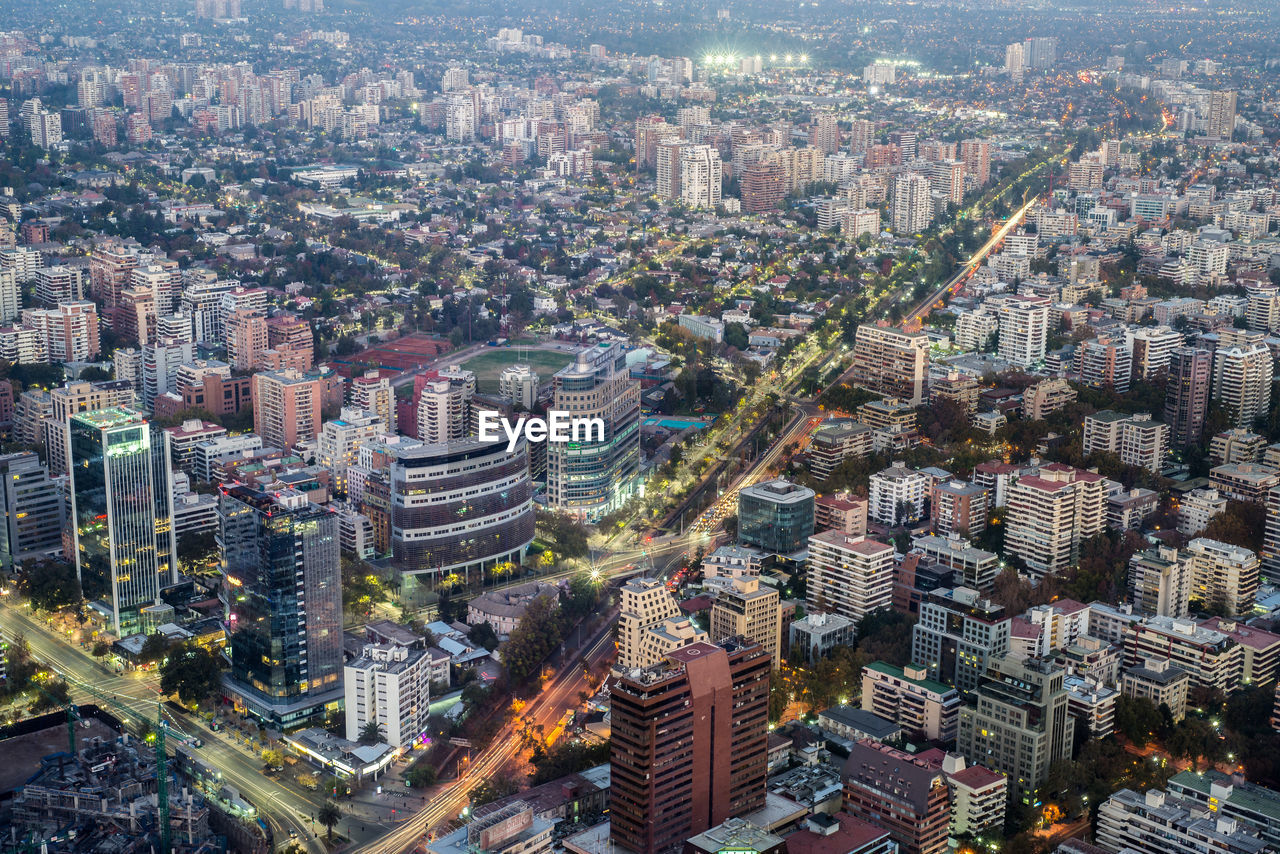 HIGH ANGLE VIEW OF ILLUMINATED CITY BUILDINGS