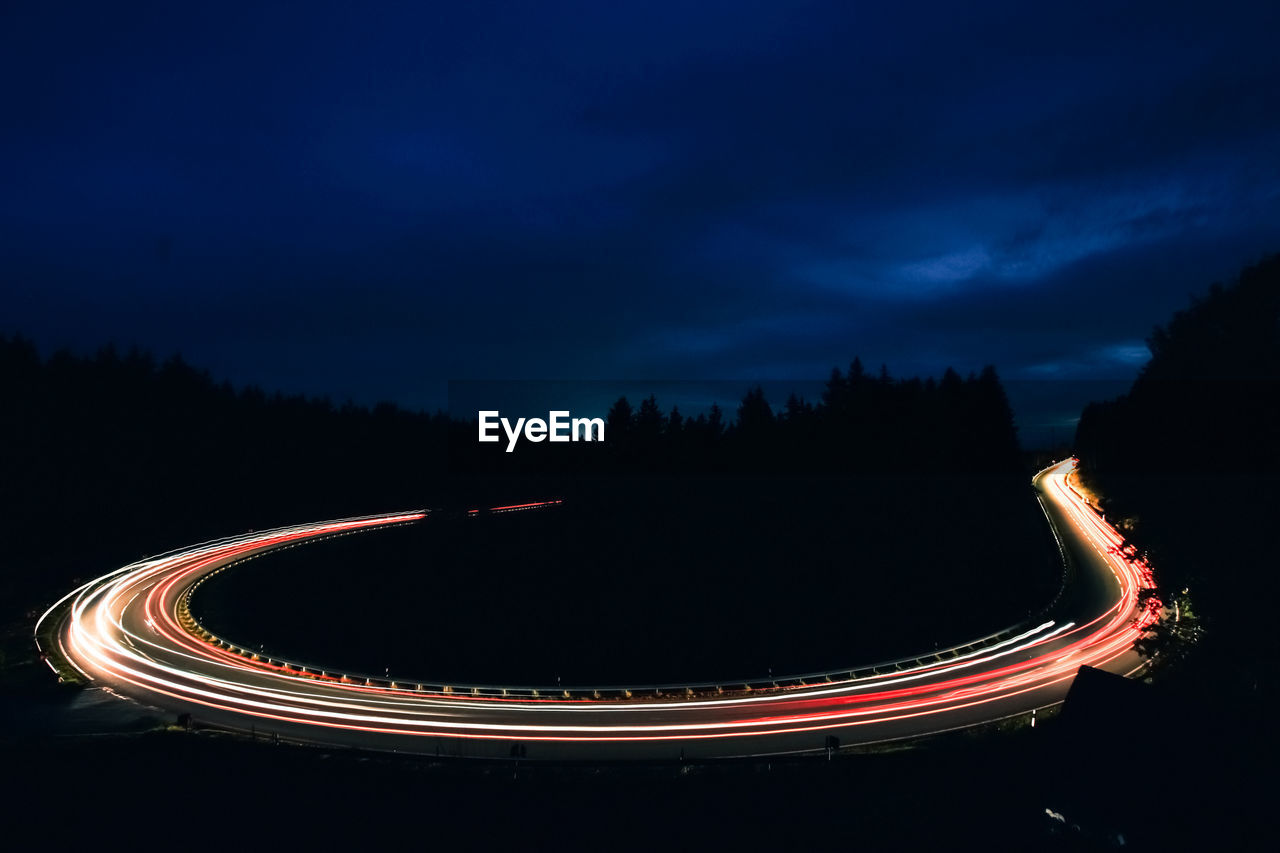 High angle view of light trails on road at night