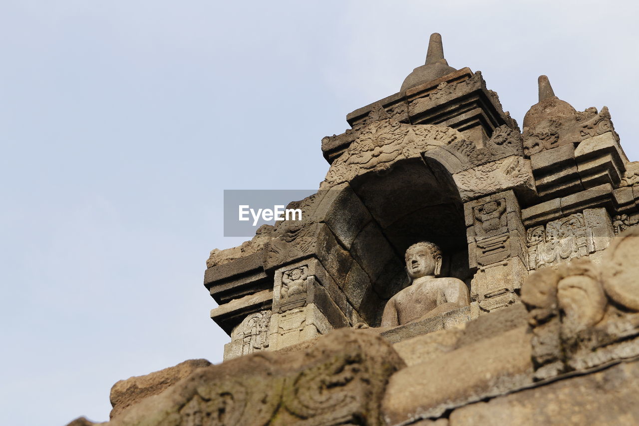 Borobudur temple with the buddha statue during sunrise, yogyakarta, indonesia