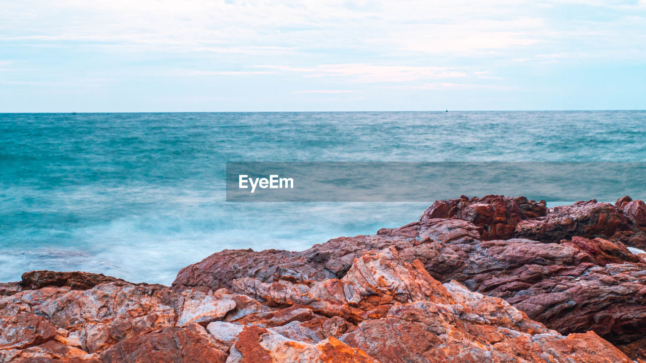 Sea ocean with smooth wave and rock landscape with blue sky. nature of seascape vacation time.