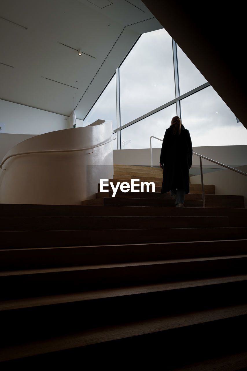 Low angle view of woman walking on steps